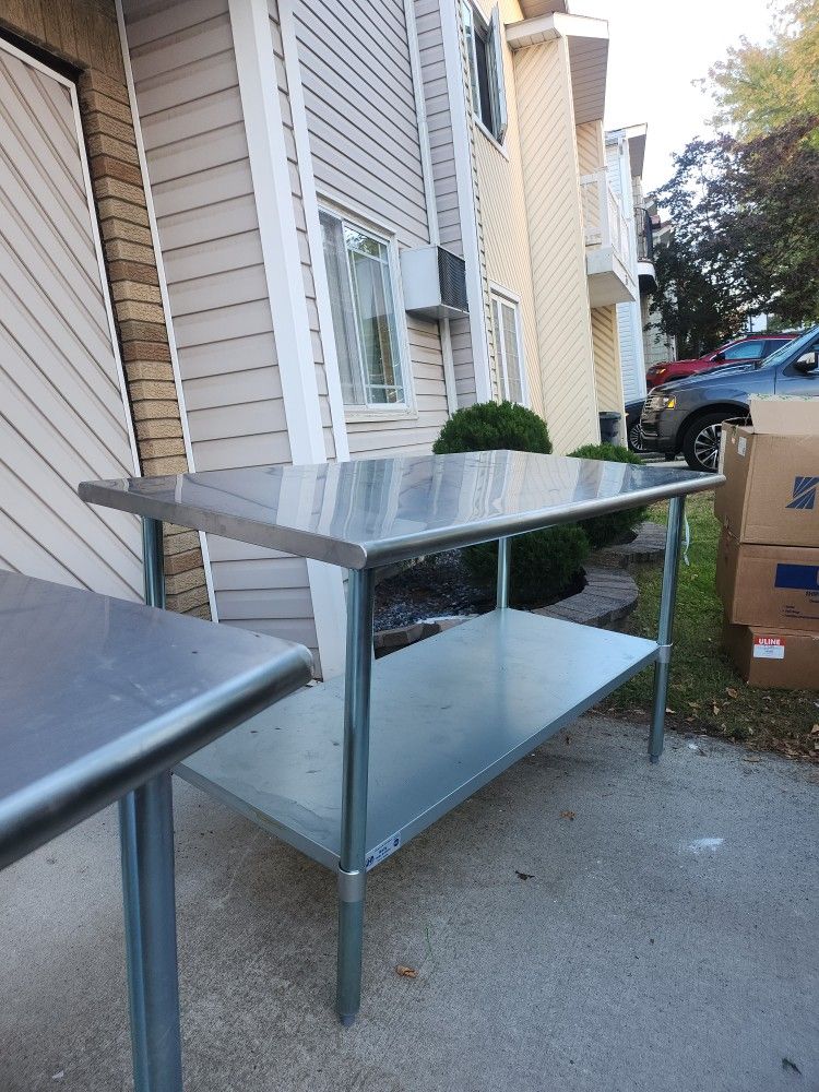 Stainless steel (2)tables 30 inches by 60 inches.