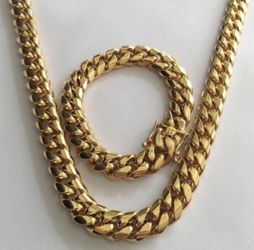 New 14 k yellow gold Cuban link chain and bracelet