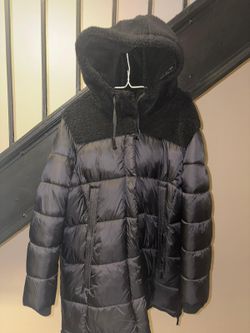 Koolaburra by UGG women's puffer jacket. It is often described as a "mixed-media" jacket because of the combination of the puffer material and a sherp