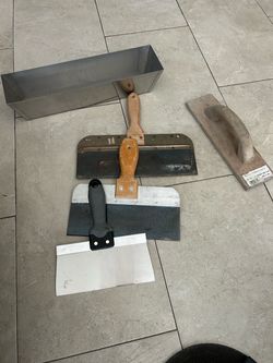 Drywall mud pan, 3 metal scrapers and wood hand float.