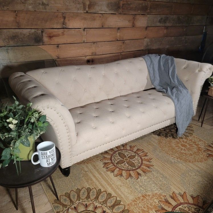 Chesterfield-style, button-tufted, rolled-arm sofa