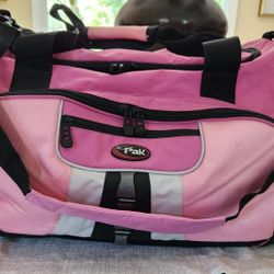 Large Travel Canvas Bag in Pink and Black. Two large side Outer Pockets with double zippers and carrying handles. Large storage compartment on top