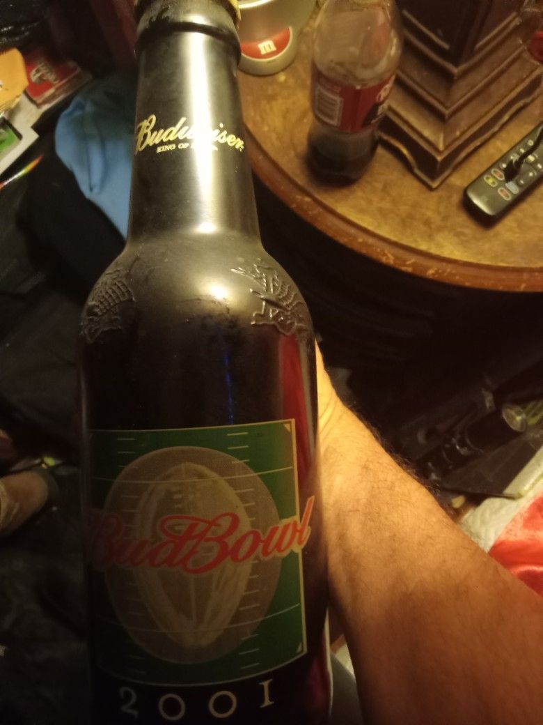 A budweiser glass bottle used for a piggy bank or whatever