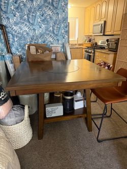 Counter height kitchen table with lazy susan built in. Seats 4.