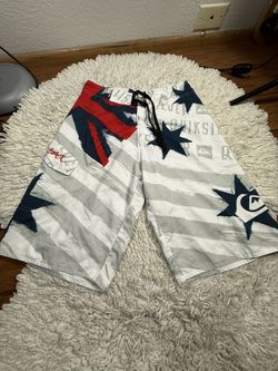 A pair of Quiksilver Kelly Slater Signature Series board shorts with a red, white, and blue USA-themed graphic design Size 32  In very good condition 