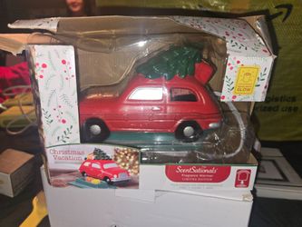ScentSationals Christmas Vacation Electric Fragrance Warmer shaped like a red car carrying a Christmas tree, featuring glowing headlights