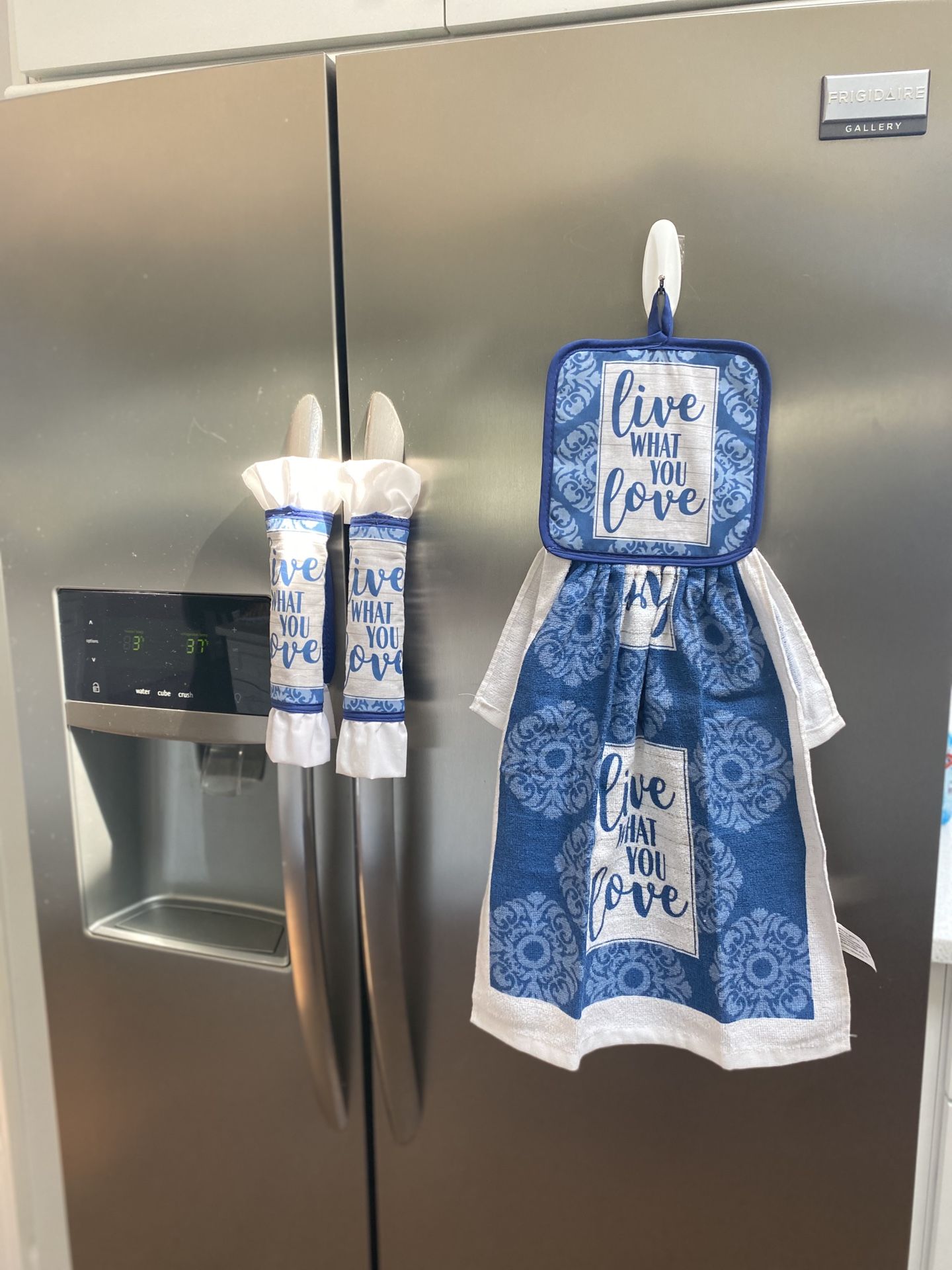 Kitchen towel with decorative pot holders.