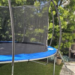 14 FT Round Trampoline with safety net.