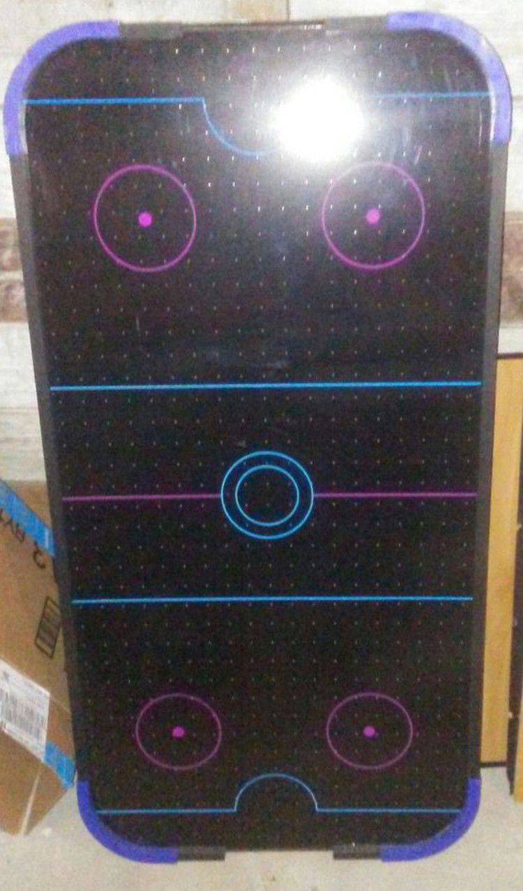 Air hockey table that stands about three and a half feet 4