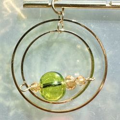 🟢 Beautiful green or iridescent & gold tone double hoop spinning beaded charm pendant or ornament