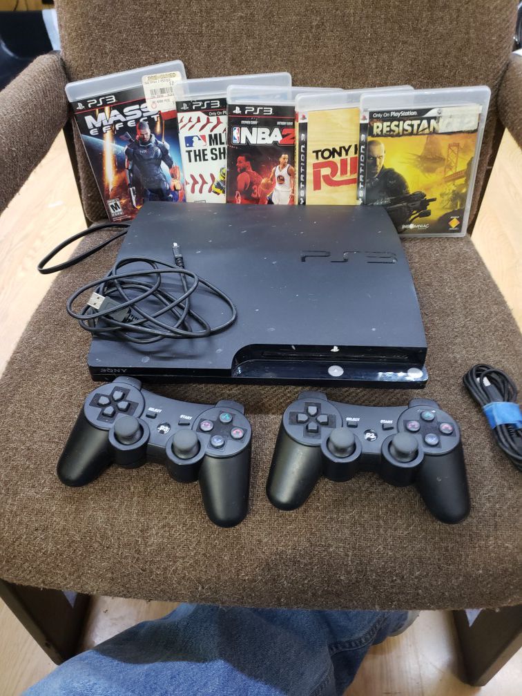 PS3 with two controllers five games and chords that goes with it $120