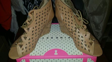 Beige pair of tie up wedge sandals