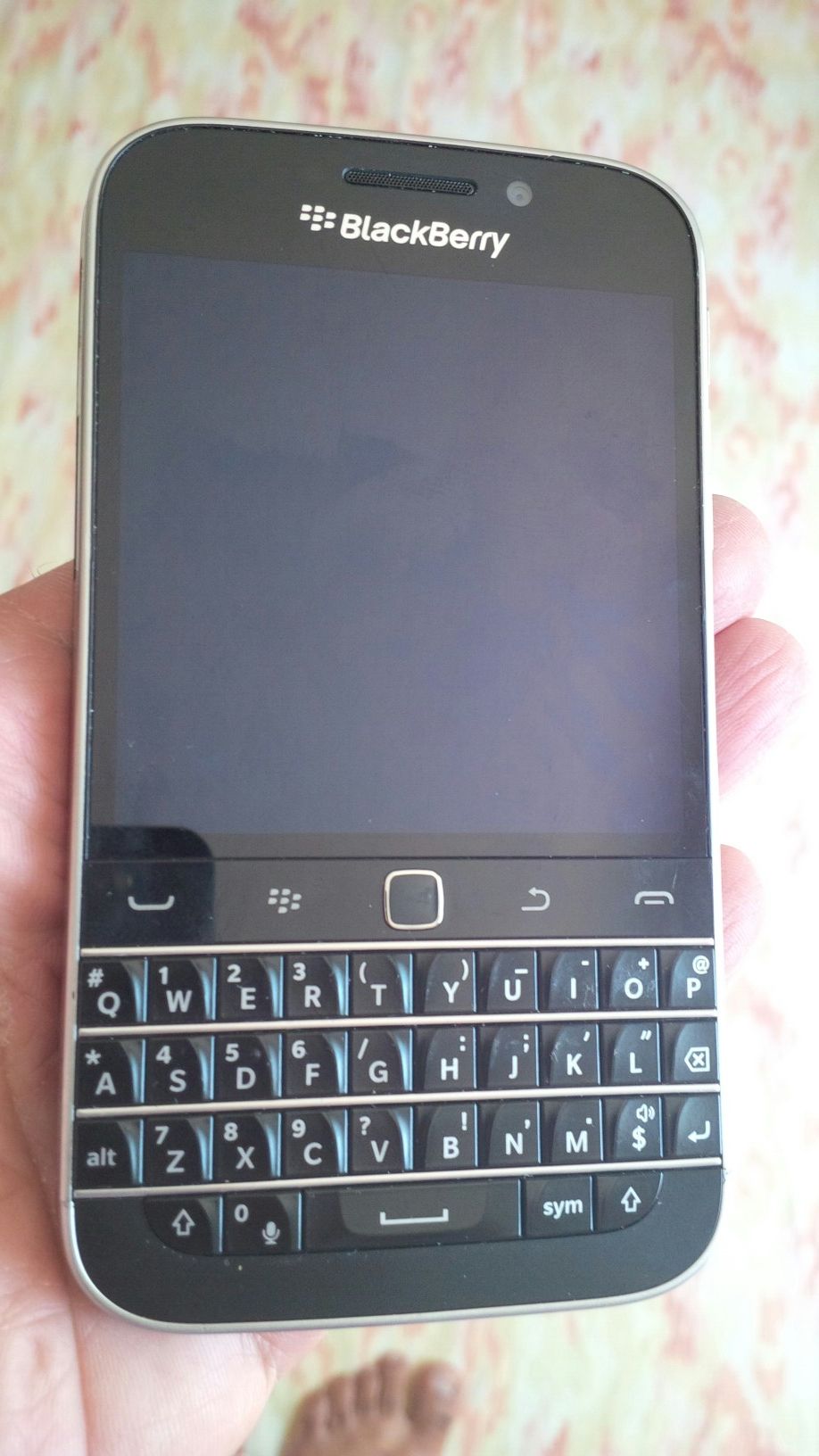 Blackberry classic Verizon unlocked hairline cracked refurbished some scratches and scuffs.