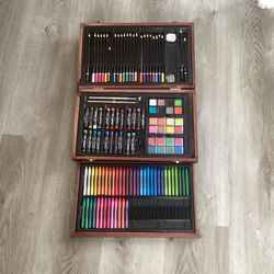 Art set with crayons, colored pencils, paint and paint, brush, pencil sharpener, eraser, and oil pastels