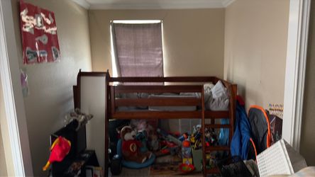 Kids bed with a slide play area underneath