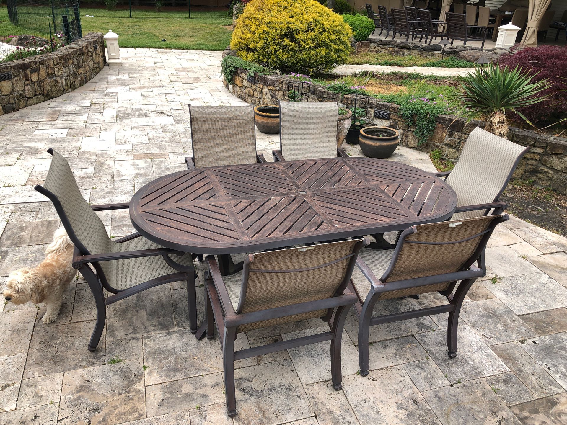 High end Powder coated metal dining room table with six arm chairs outdoors