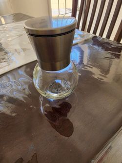 MAPCO manual grinder with a glass storage jar and stainless steel top.
