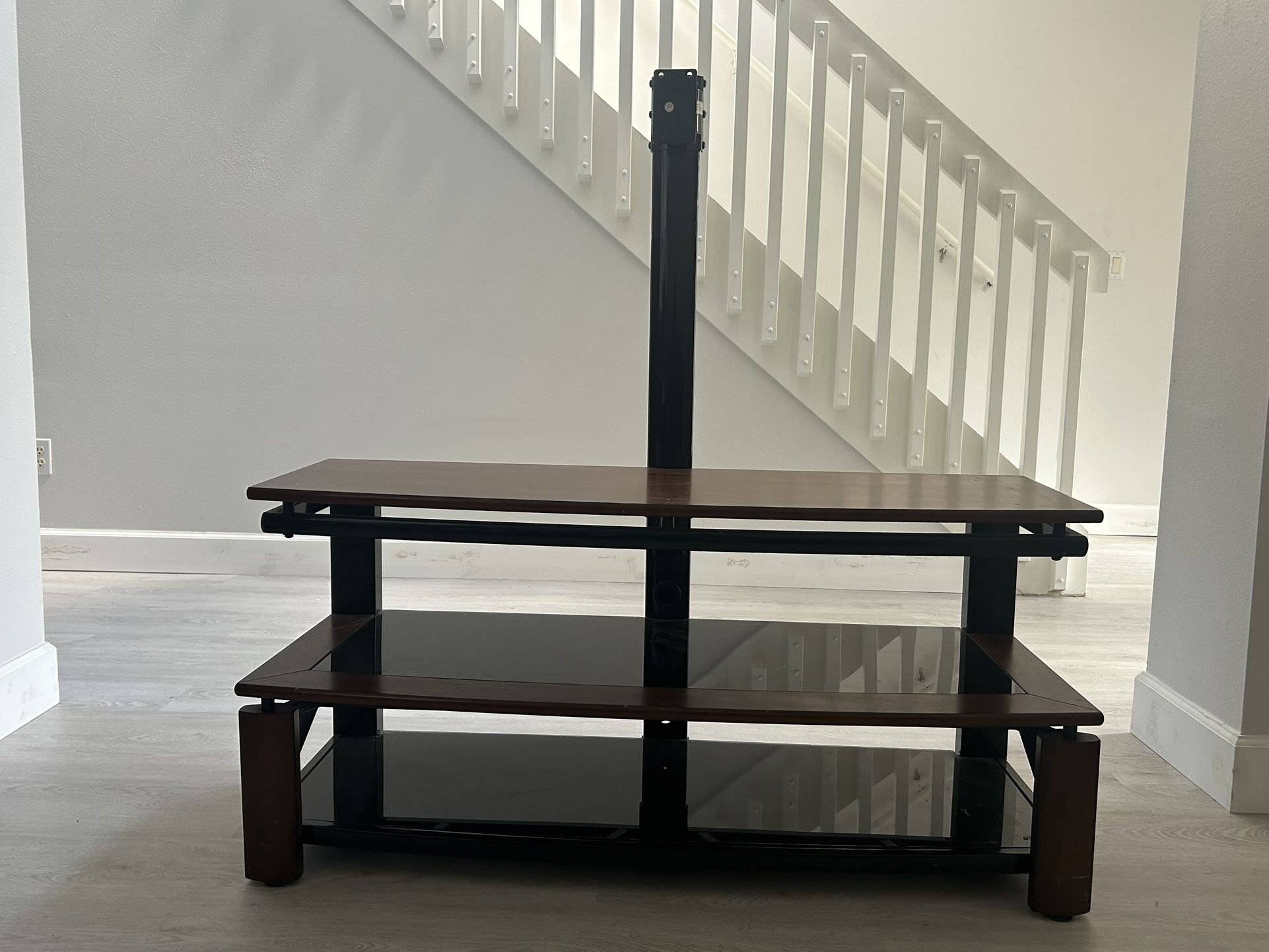 TV Stand: Black Metal Frames, Wood Color Borders, Black Glass Shelves
