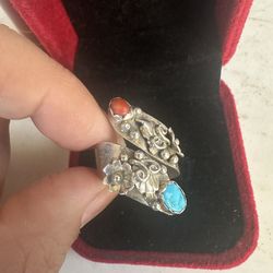 Vintage 925 Sterling silver genuine turquoise and coral bi pass ring , adjustable size , Native American, not signed , tested and guaranteed . Has squ