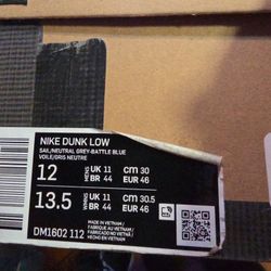 Off-White x Nike Dunk Low "Lot 10 of 50" sneakers in white leather and soft grey canvas overlays. 