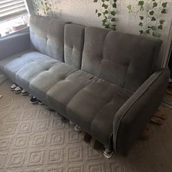 Grey futon with grey legs, and cup holders!