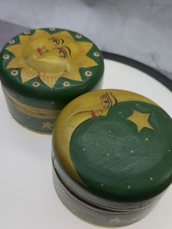 Vintage Set of Indonesian hand-carved wooden trinket boxes featuring celestial sun and moon designs. These decorative lidded shallow containers are of
