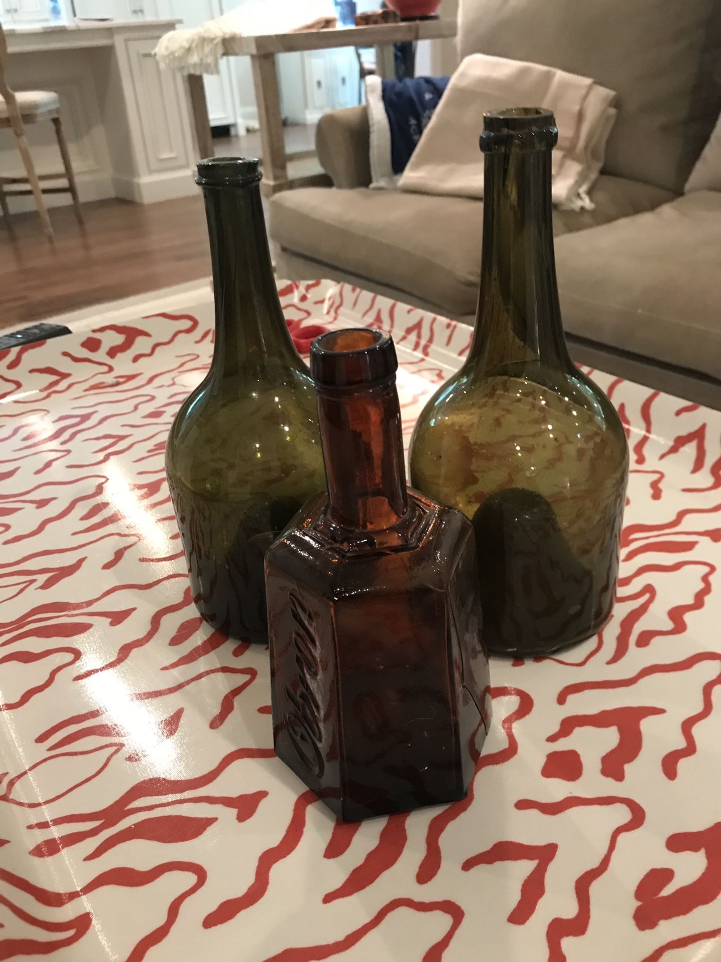 Three decorative glass bottles