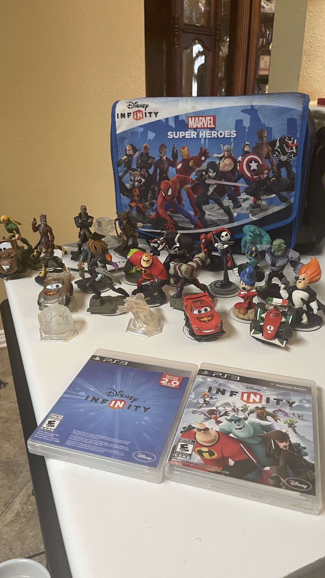 lot of 21 Disney infinity figures, portal, 2 PS3 video games and carrying case