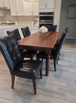 Good Quality Dining Set. Solid Wood World Market Table With 6 Real Leather   
Chairs. Very Comfortable! Used, in good condition. Normal Wear!

Table 

