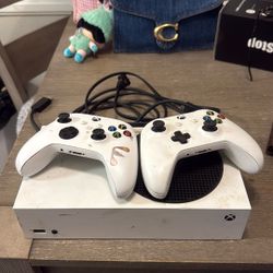 Xbox S With Two Controls Hdmi And Plugged For Power One Control Has A Rechargeable Battery No Charger. The Other One Does Not Have A Battery 