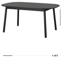 black oval Ikea table with 4 chairs 