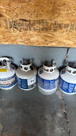 Propane tanks.  Four   Slightly new