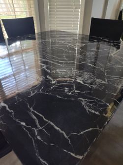Black marble high table square with four chairs.
