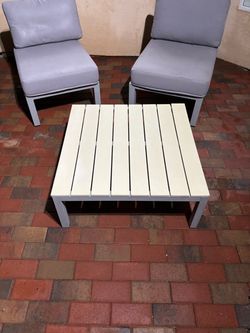 Modern 5-piece outdoor set includes 4 armless lounge chairs and one square coffee table. The chairs have gray metal frames with matching thick gray ys