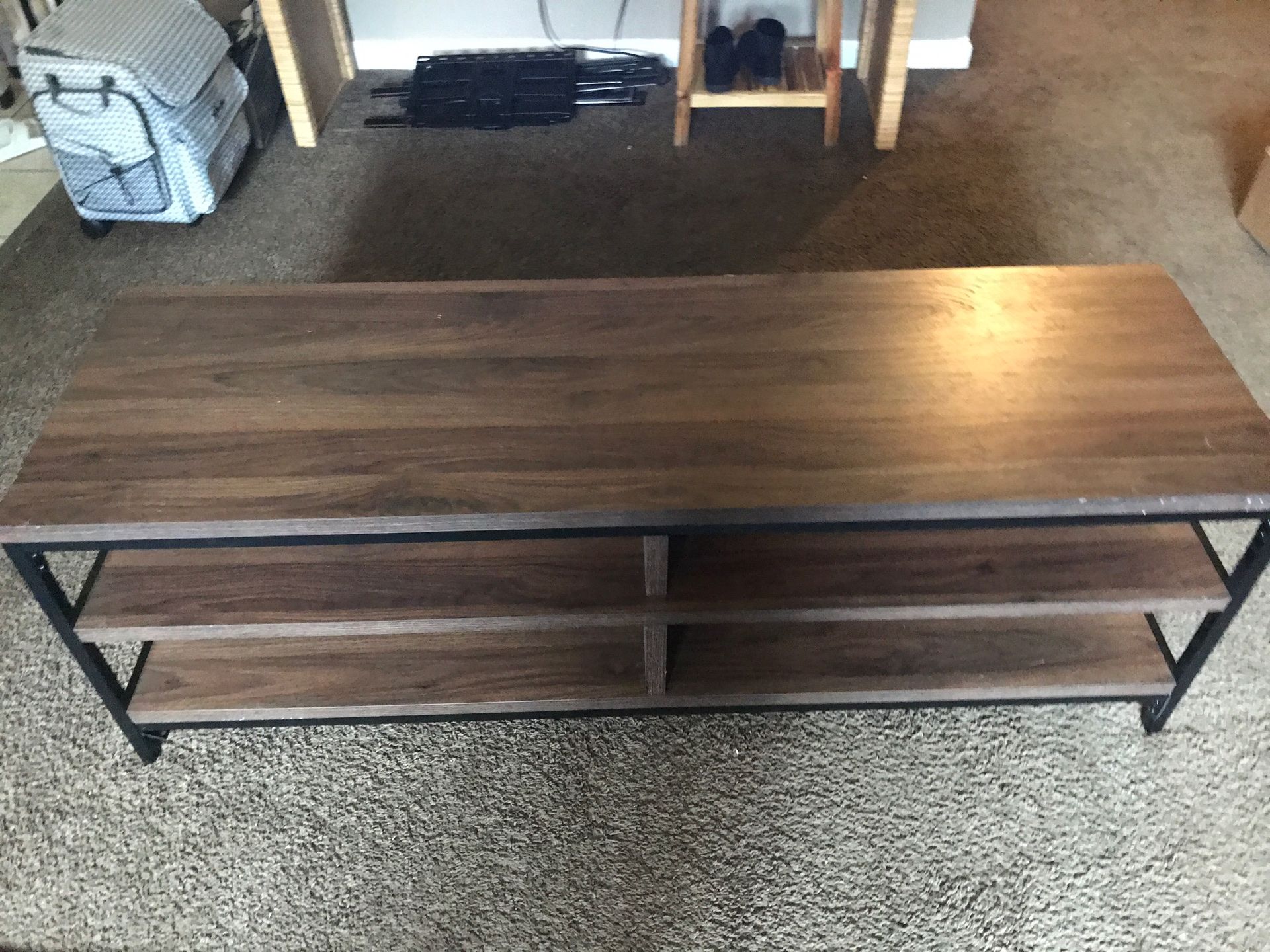 Tv console will hold up to a 70inch tv solid brown wood with metal black legs