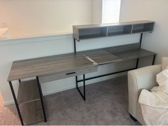 Gray desk wood has a area missing paint