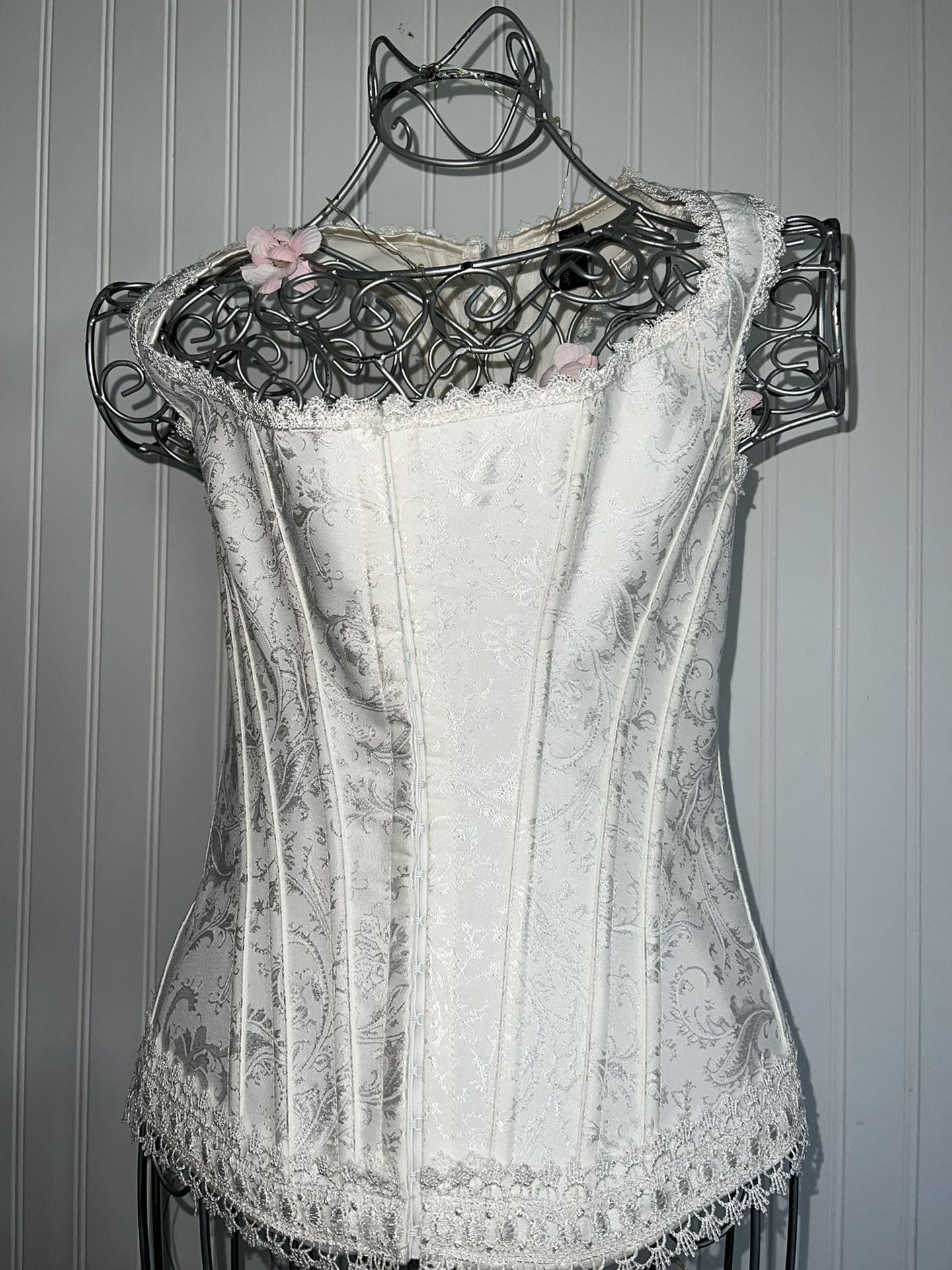 Cream colored corset top. Hook and eye closure in front. Ribbon corset ties in back Size 36