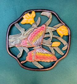 Pretty and vintage cast iron butterfly and floral trivet with feet