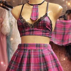 Turn heads with this stylish two-piece set featuring a lace-trim bralette, matching pleated skirt, and cute tie detail. Soft, comfortable, and perfect
