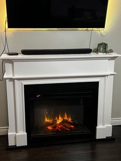 Large electric fireplace with wood mantle