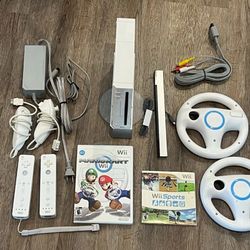 Nintendo WII With Mario Kart + WII Sports and  2 WHeels and 2 Remotes
