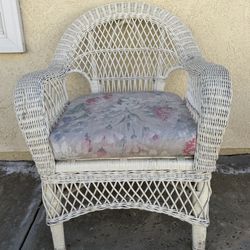 White Wicker Armchair with Floral Cushion
