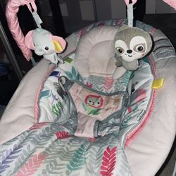Baby bouncer with soothing vibrations and music.