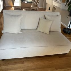 Two Beige Armless Sofas