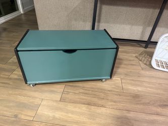 Wooden toy chest with rolling wheels