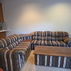 L shaped couch with corner table and coffee table