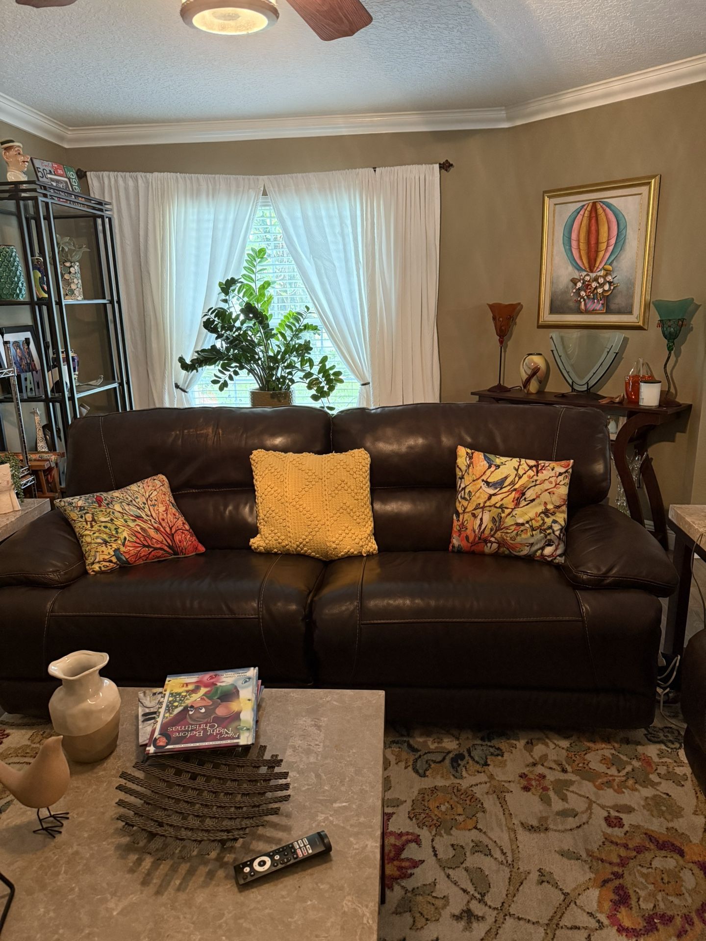 Brown Leather Reclining Sofa’s. One Electric, One Manual.