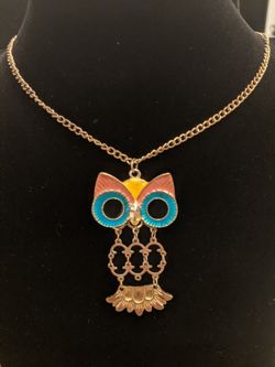 $10. Gold tone articulated owl pendant necklace. Pendant has yellow, pink, blue, and black enamel.