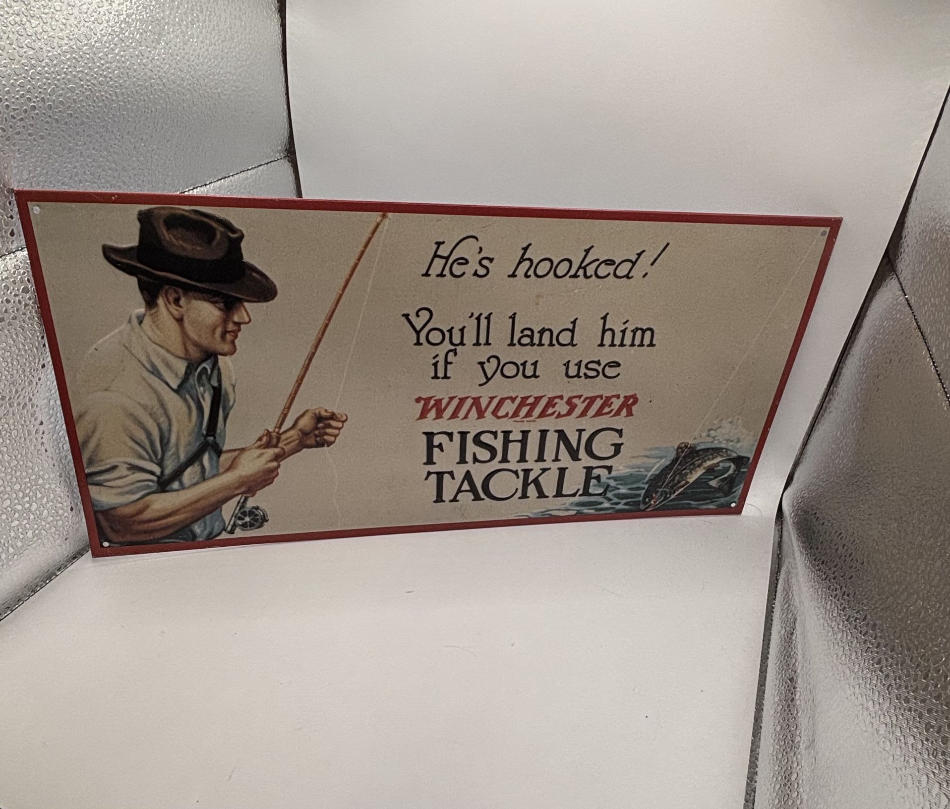 Winchester "He's Hooked" Fishing Tackle Vintage Metal Sign (14”x8”)