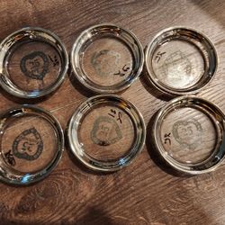 set of 6 vintage glass coasters with silver-colored rims,  made for a 25th anniversary. 